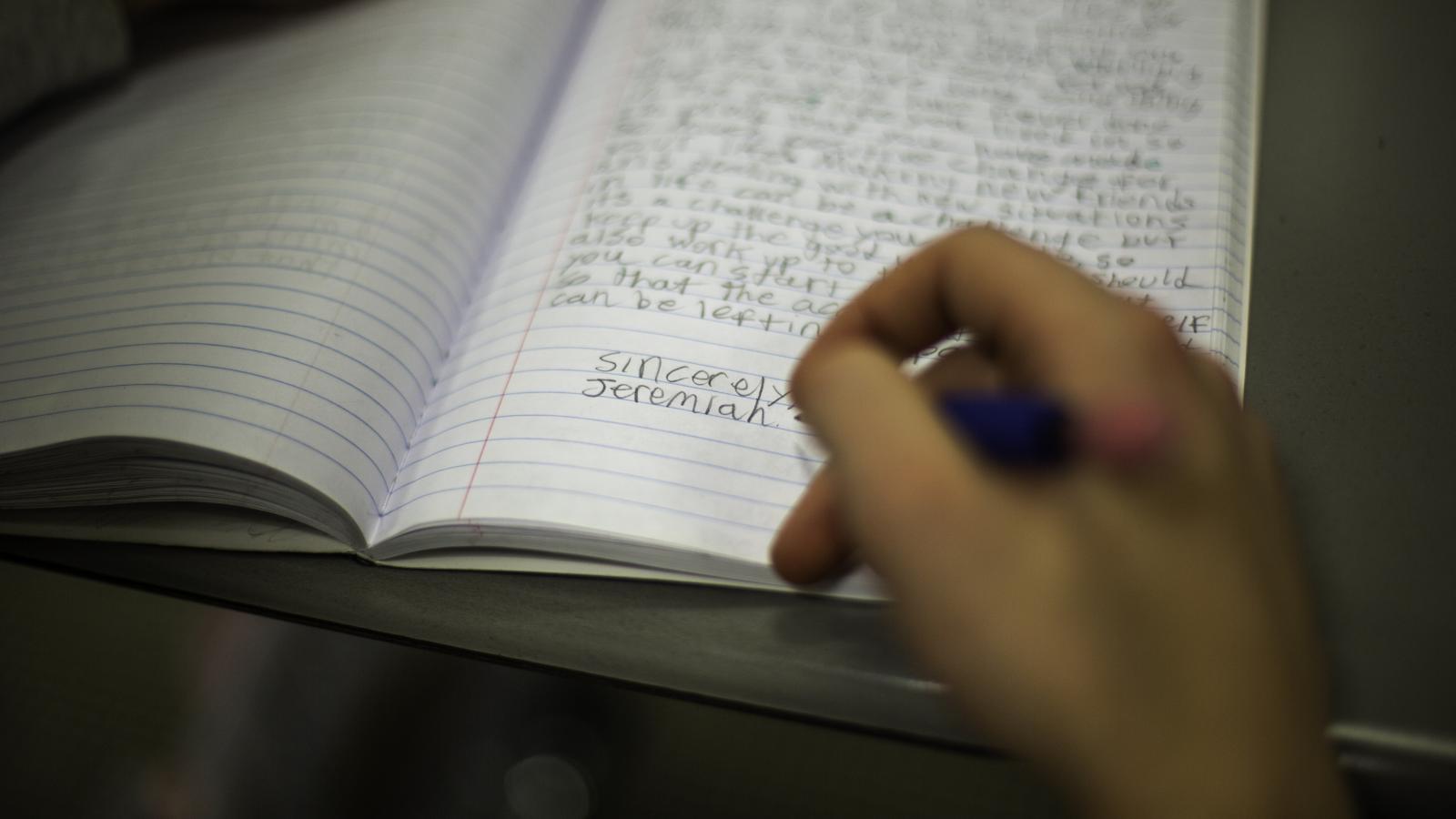Close-up view of a handwritten passage in a student's composition book