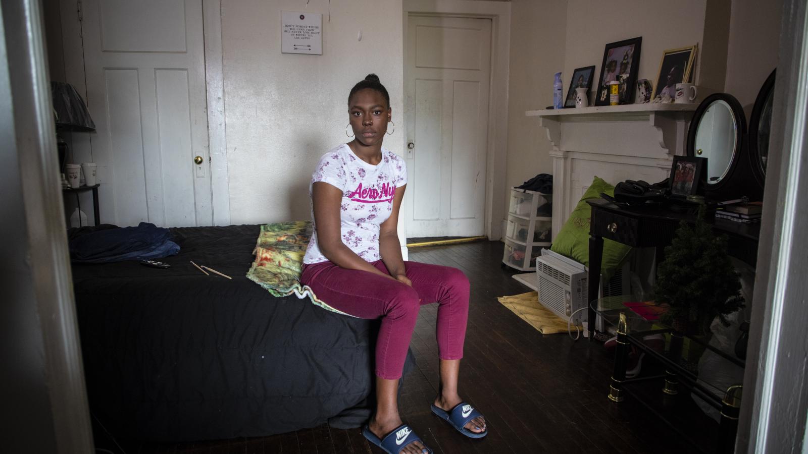 Teenager seated in a residential bedroom