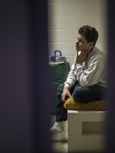 Narrow view of teenager in a juvenile facility bedroom